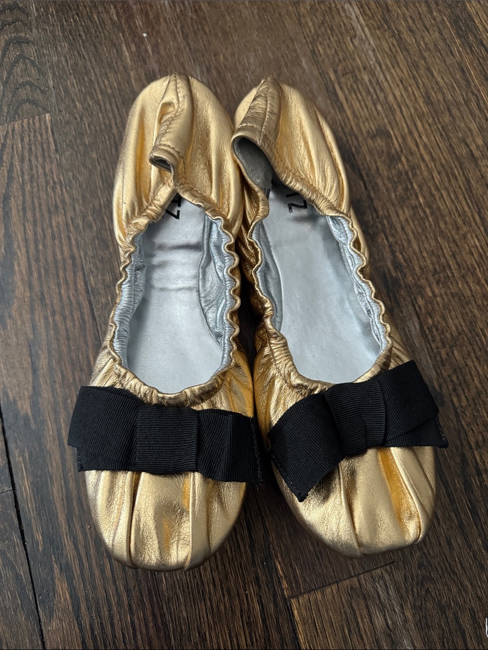 SCHUTZ Metallic Gold Ballet Flats with Black Bow Accent